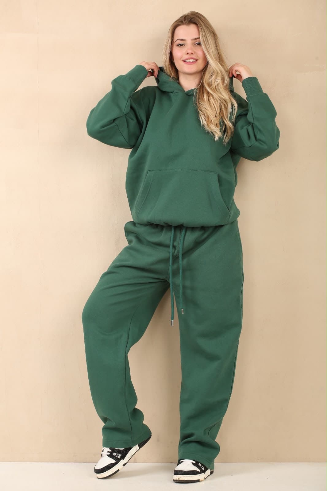 Model in a forest-green hoodie and jogger set
