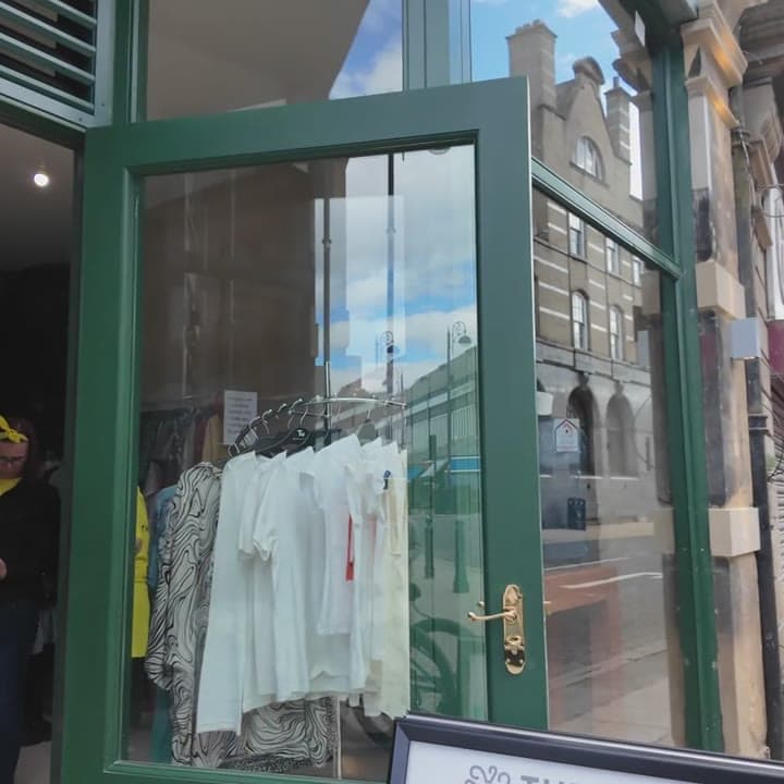 Crisp shirts hanging on the rail inside an arcade boutique